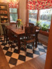 Pura Vida customer use of Diamonds vinyl floor cloth in a dining room