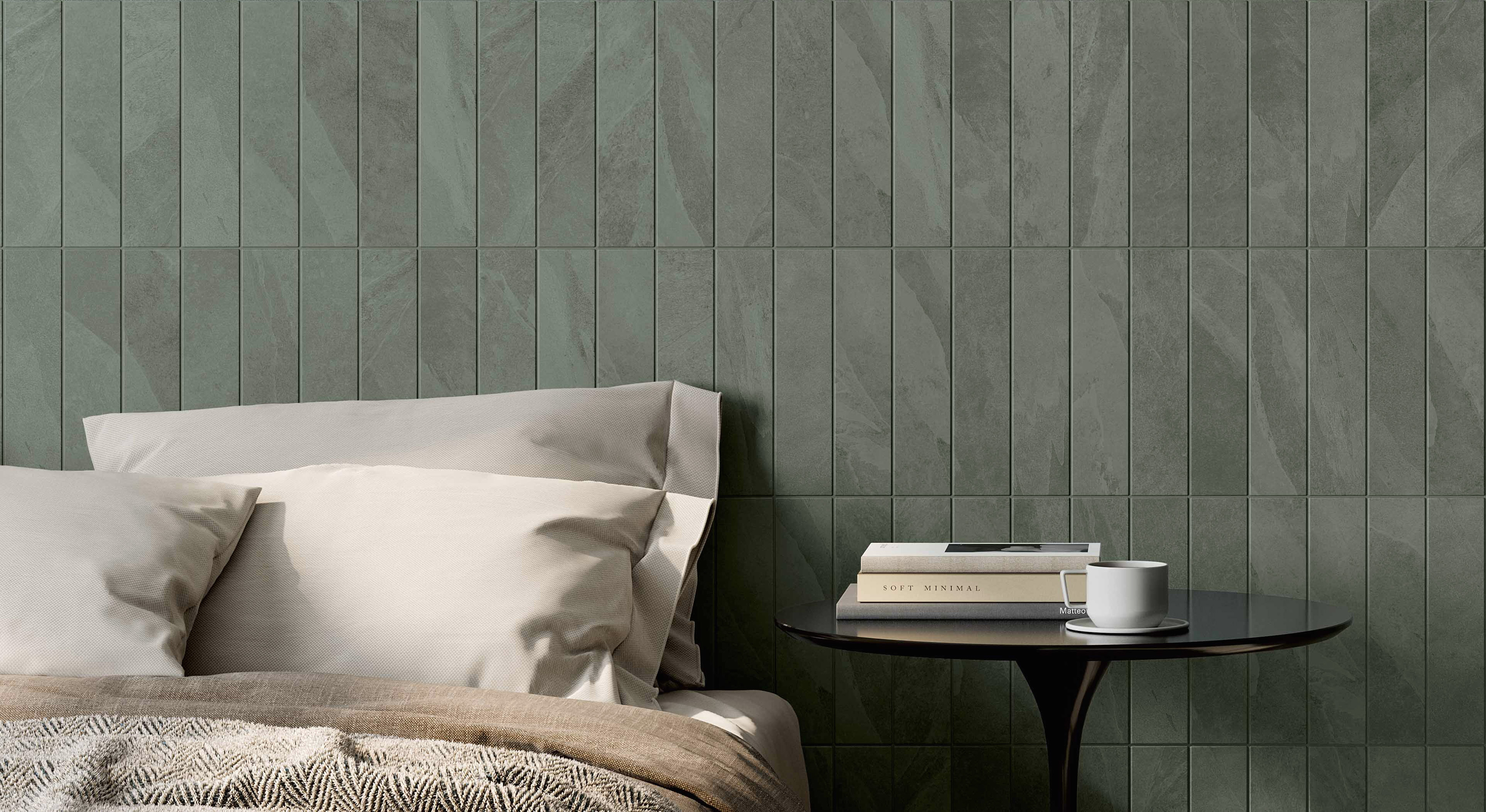 Bedroom with green tiles on a wall