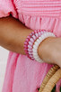 Model wearing Teleties Large Hair Ties Made me Blush as bracelets