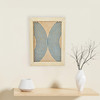 embroidery in wood home decor piece pin pin blue embroidery in wood against cream wall with white flower vase on shelf by artist atinuke adeleke for zuri perle b