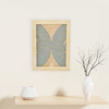embroidery in wood home decor piece oyin blue embroidery in wood against cream wall with white flower vase on shelf by artist atinuke adeleke for zuri perle 