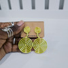 Hand holding contemporary cultural jewelry Fumi light green 3D printed symbolic statement earrings by dallas brand zuri perle