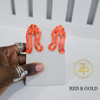 Hand holding contemporary cultural jewelry Iyun Okan Red and Gold 3D printed symbolic statement earrings by dallas brand zuri perle Hand holding contemporary cultural jewelry Iyun Okan Red and Gold 3D printed symbolic statement earrings by dallas brand zuri perle