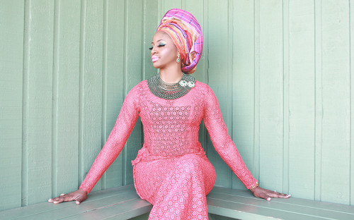 African model sitting on a wooden bench and background image used for ibale okan embroidery home decor by zuri perle African model sitting on a wooden bench and background image used for ibale okan embroidery home decor by zuri perle