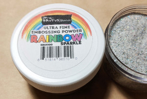 Rainbow sparkle embossing powder. Once heat melted it dries clear with rainbow glitter sparkle