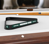 Michigan State Spartans billiard triangle displayed on a pool table beneath billiard cues, showcasing the black frame, green and white team graphics, and Michigan State lettering in a game room setting.