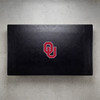 Oklahoma Sooners pool table cover shown from above, featuring a black cover design with the red Oklahoma “OU” logo centered on the surface. This NCAA billiard table cover is designed to protect the table while showcasing University of Oklahoma team pride.