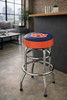 Auburn Tigers chrome bar stool displayed in a home entertainment setting, featuring a blue and orange team logo seat with a polished chrome base. This college team stool is perfect for adding Auburn spirit to a fan cave, home bar, pool room, or game room.