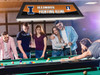 Lifestyle view of the Illinois Fighting Illini 42-inch hanging billiard table light installed above a pool table, demonstrating its appearance in a game room, billiard room, home bar, or Illini fan cave.