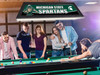 Lifestyle view of the Michigan State Spartans 42-inch hanging billiard table light installed above a pool table, demonstrating its appearance in a game room, billiard room, home bar, or Spartans fan cave.
