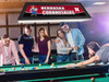 Lifestyle view of the Nebraska Cornhuskers 42-inch hanging billiard table light installed above a pool table, demonstrating its appearance in a game room, billiard room, home bar, or Cornhuskers fan cave.