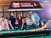 Lifestyle view of the Oklahoma Sooners 42-inch hanging billiard table light installed above a pool table, demonstrating its appearance in a game room, billiard room, home bar, or Sooners fan cave.