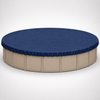 24' round above-ground winter pool cover installed on a beige round swimming pool, showing the dark blue cover fitted securely around the pool perimeter for off-season protection.