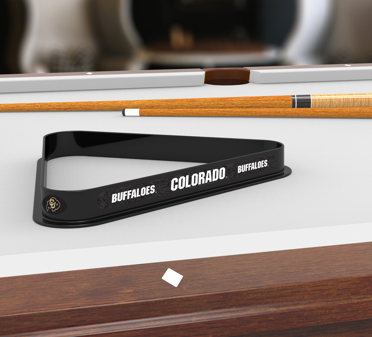 Colorado Buffaloes billiard triangle displayed on a pool table in a billiard room setting, showcasing the black team-themed rack and Colorado Buffaloes graphics alongside pool cues.
