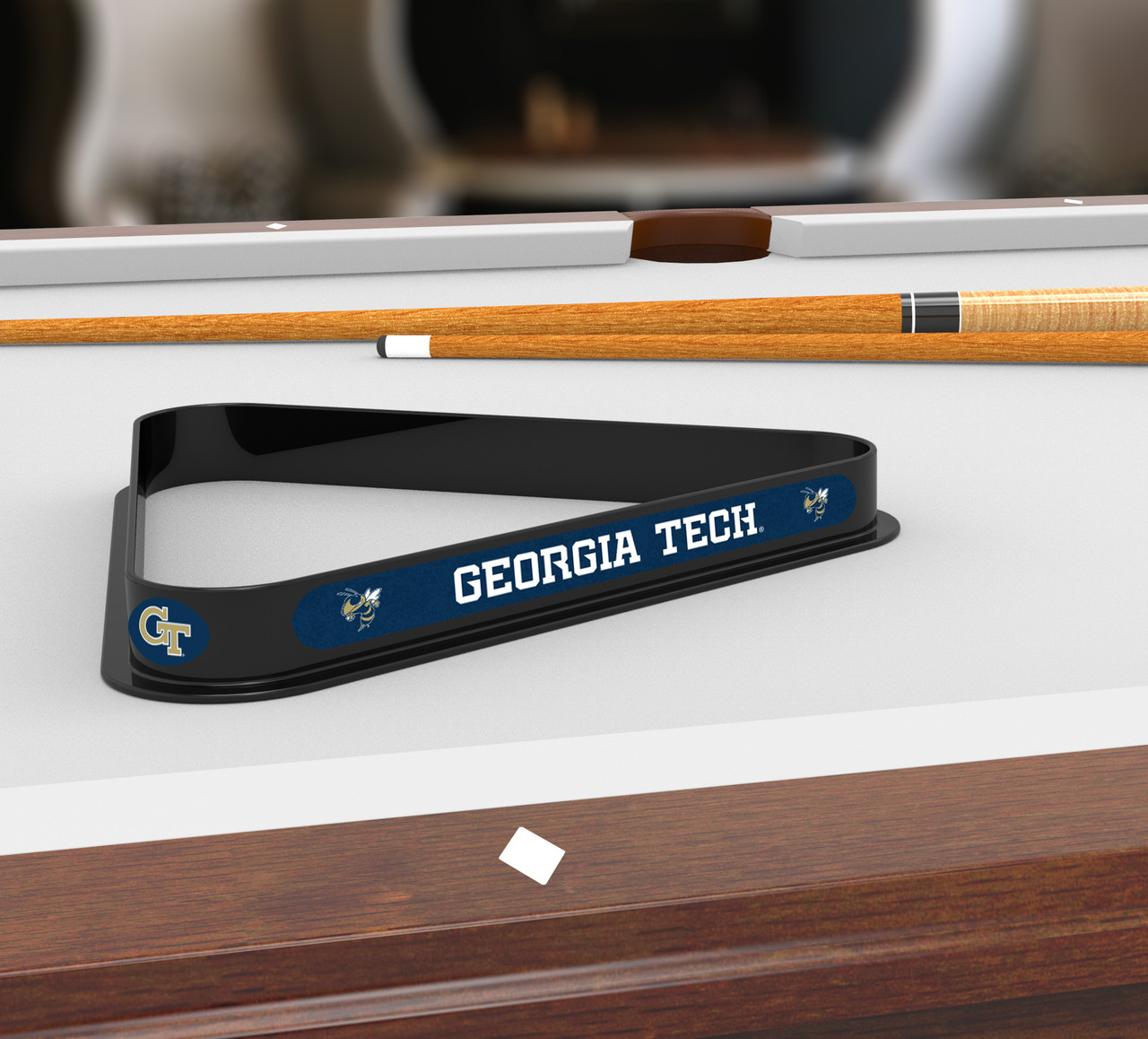 Georgia Tech Yellow Jackets billiard triangle displayed on a pool table beneath billiard cues, showcasing the black frame, Georgia Tech lettering, and team graphics in a game room setting.