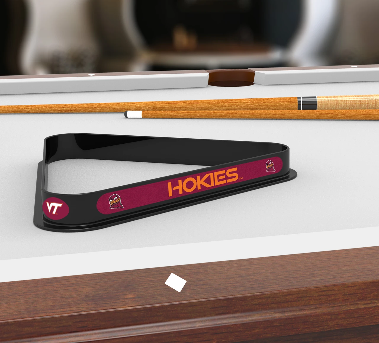 Virginia Tech Hokies billiard triangle displayed on a pool table beneath billiard cues, showcasing the black frame, maroon and orange Hokies graphics, and Virginia Tech branding in a game room setting.