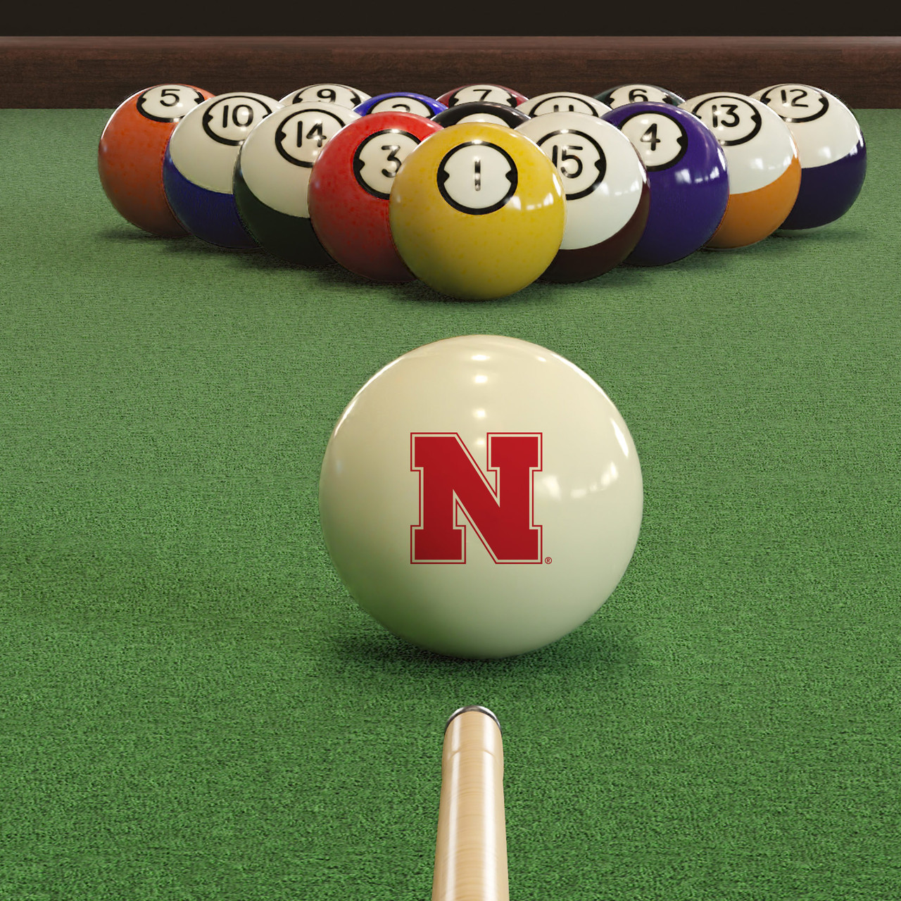 Nebraska Cornhuskers cue ball positioned on green pool table felt in front of a racked set of billiard balls, featuring the red Nebraska Block N logo with a pool cue lined up for the break.