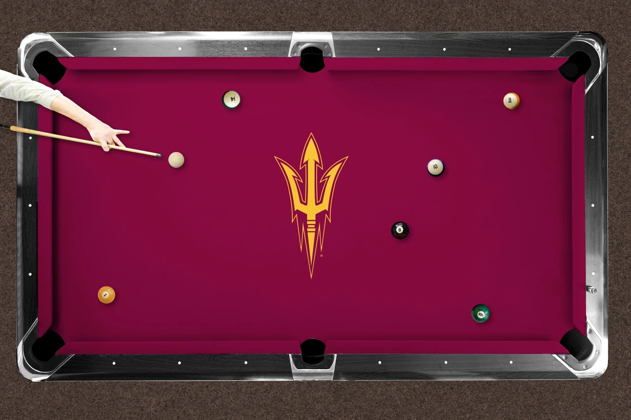 Top-down product view of Arizona State Sun Devils pitchfork logo billiard cloth installed on a traditional wood-rail pool table. The maroon playing surface features the Arizona State pitchfork logo centered on the table.
