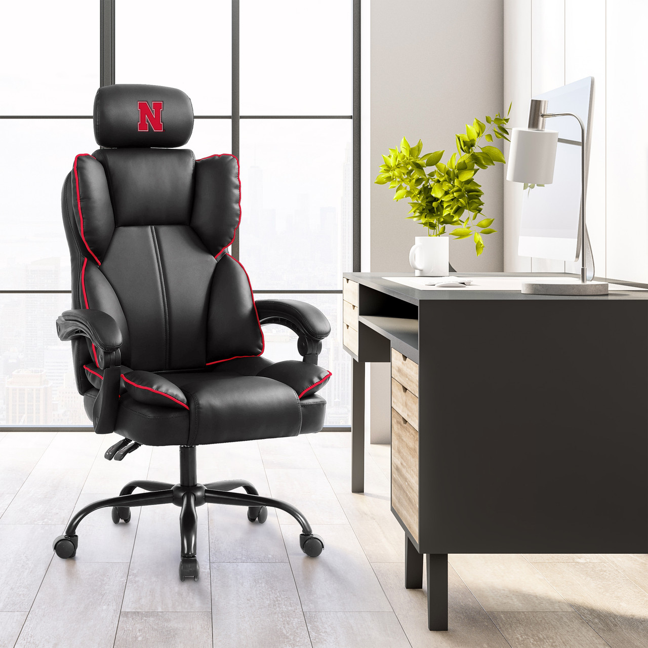 Nebraska Cornhuskers oversized gaming chair shown in a modern home office setting with black, gray, and red team-inspired design.