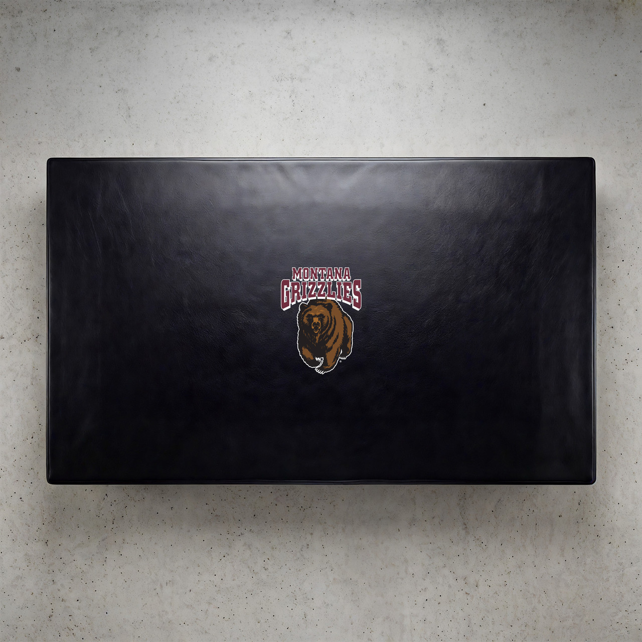 Montana Grizzlies pool table cover shown from above, featuring a black cover design with the Montana Grizzlies logo centered on the surface. This NCAA billiard table cover is designed to protect the table while showcasing University of Montana team pride.