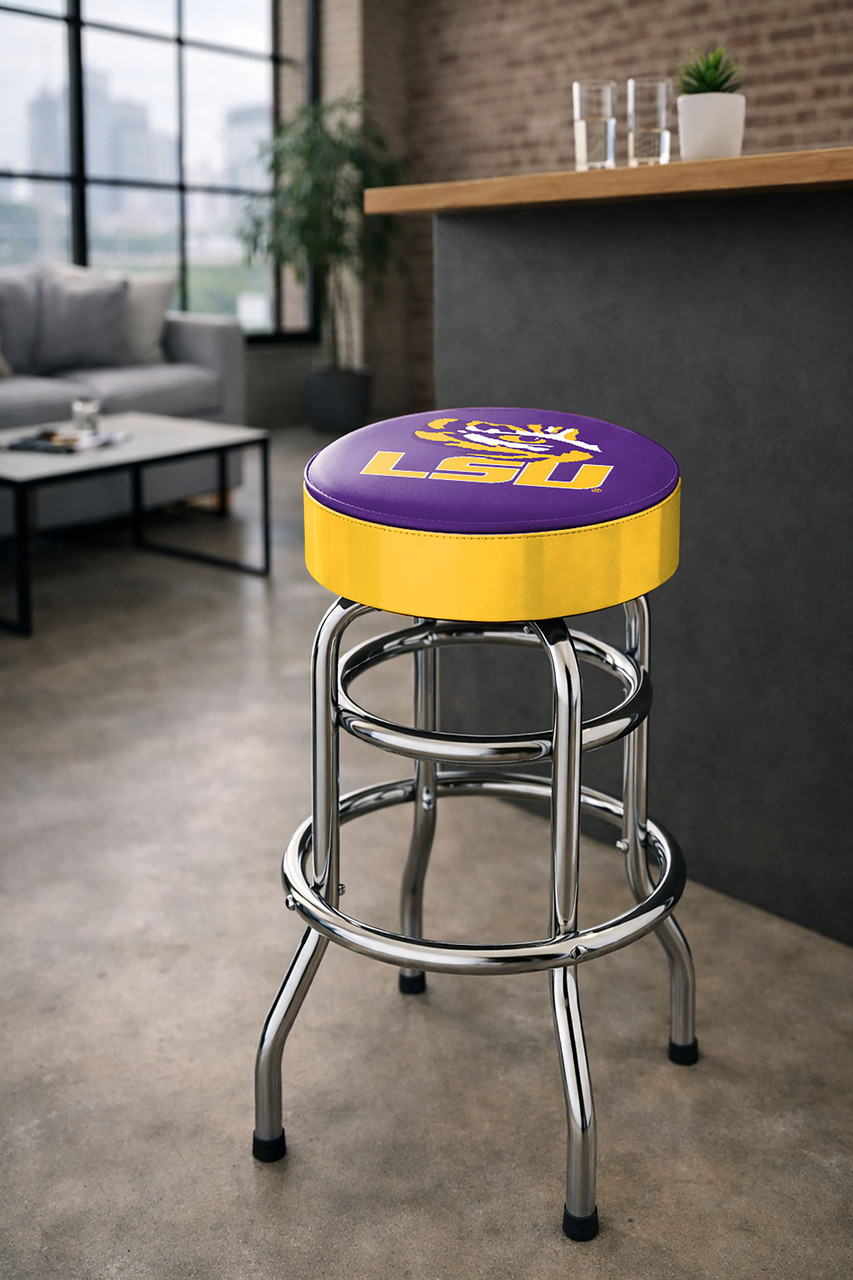 LSU Tigers 30" chrome bar stool displayed in a home entertainment setting, featuring a purple and gold team logo seat with a polished chrome base. This college team stool is perfect for adding LSU spirit to a fan cave, home bar, pool room, or game room.