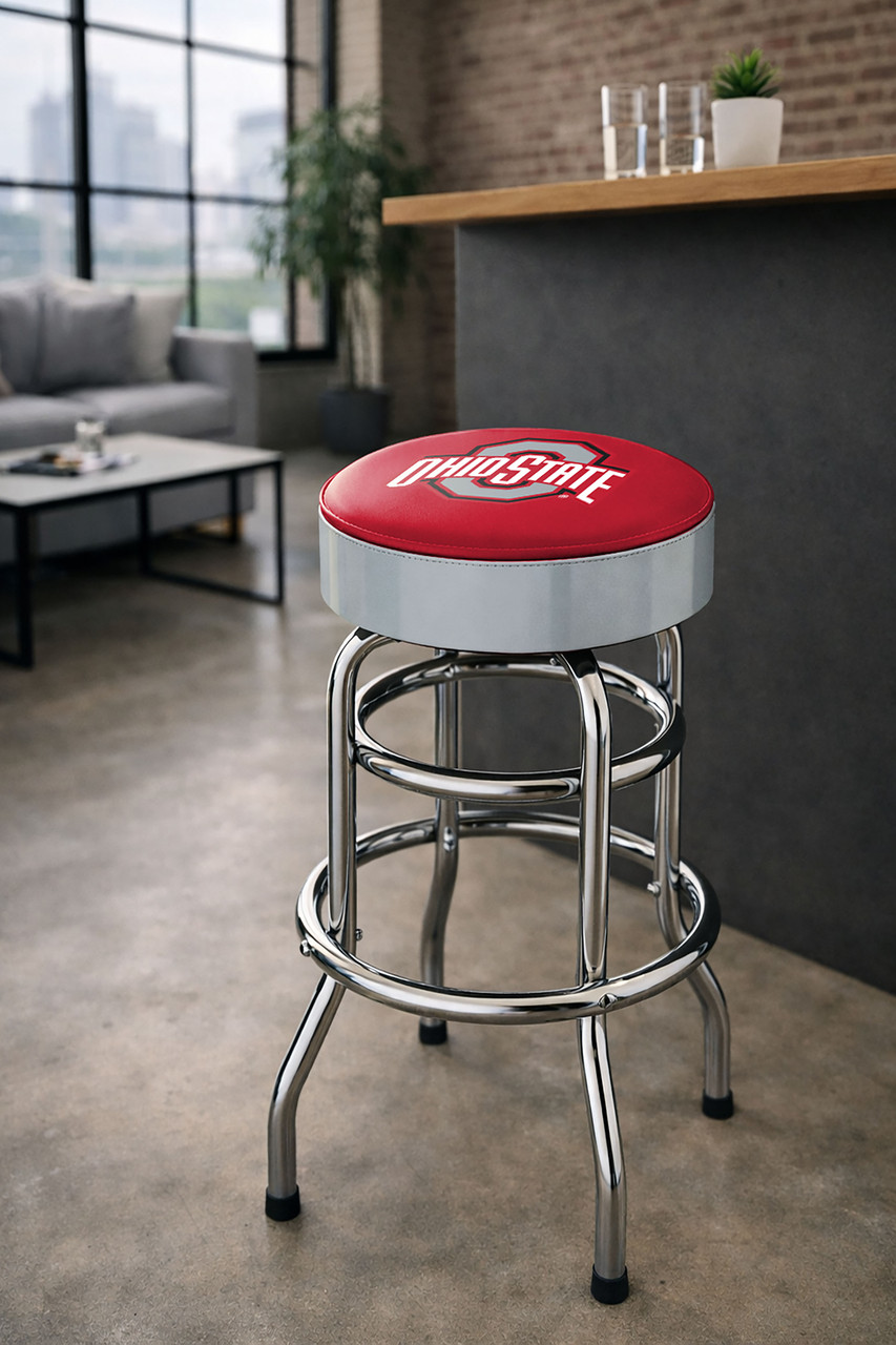 Ohio State Buckeyes 30" chrome bar stool displayed in a home entertainment setting, featuring a scarlet and gray team logo seat with a polished chrome base. This college team stool is perfect for adding Ohio State spirit to a fan cave, home bar, pool room, or game room.