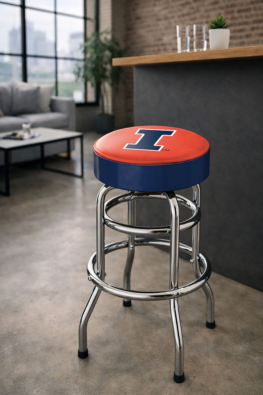 Illinois Fighting Illini 30" chrome bar stool displayed in a home entertainment setting, featuring an orange and navy team logo seat with a polished chrome base. This college team stool is perfect for adding Illinois spirit to a fan cave, home bar, pool room, or game room.