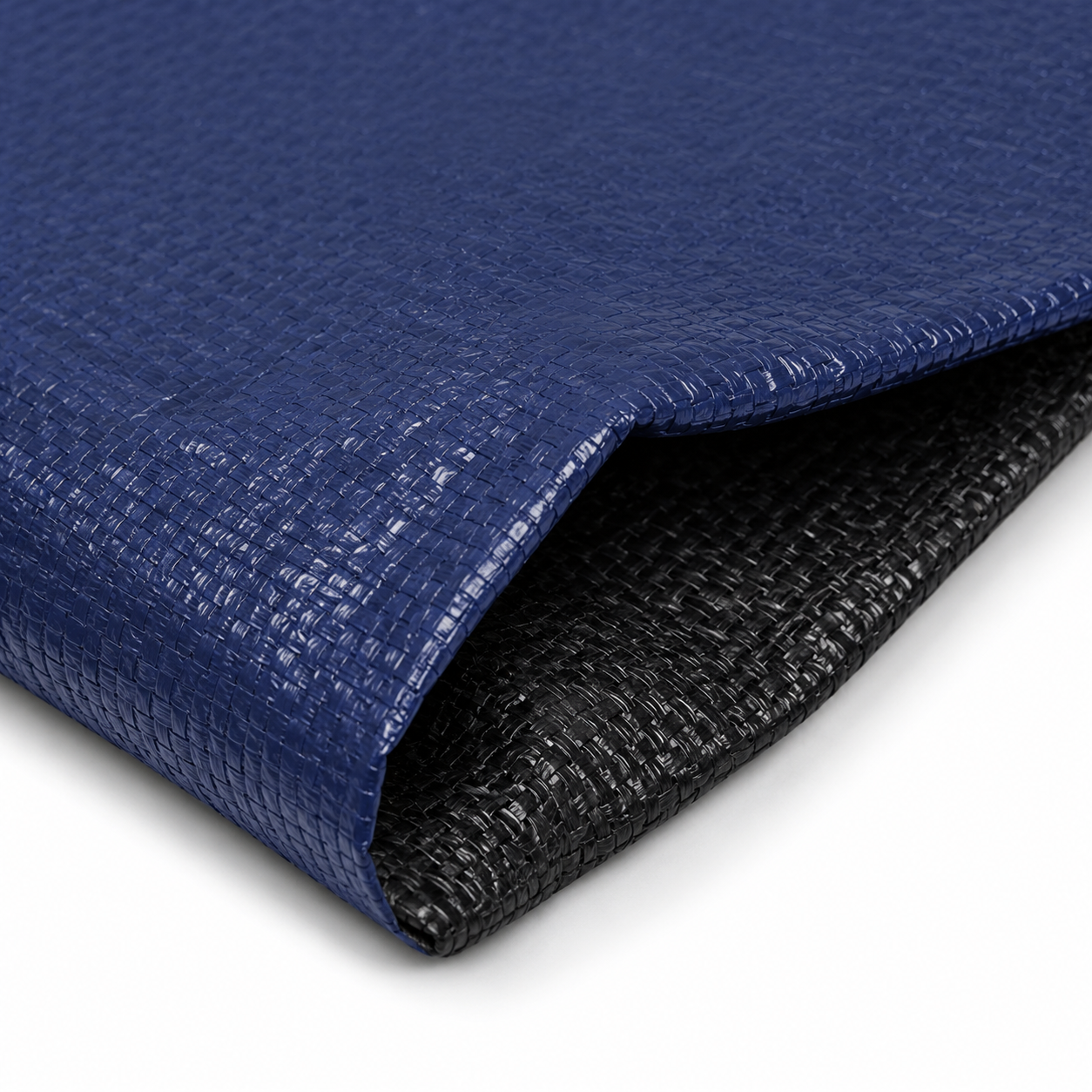 Close-up detail image of the winter pool cover material, showing the dark navy top layer and black underside. The image highlights the cover’s textured woven construction and layered material design.