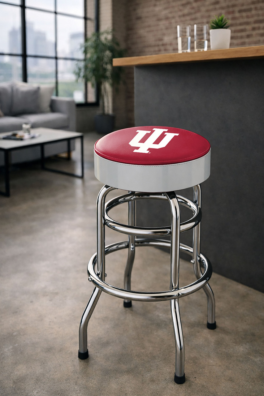 Indiana Hoosiers 30" chrome bar stool displayed in a home entertainment setting, featuring a crimson and white team logo seat with a polished chrome base. This college team stool is perfect for adding Indiana spirit to a fan cave, home bar, pool room, or game room.