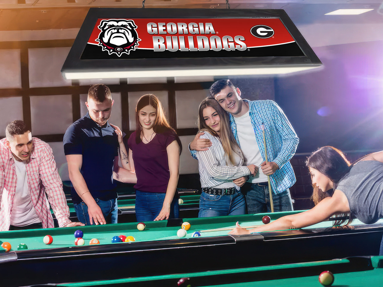 Lifestyle view of the Georgia Bulldogs 42-inch hanging billiard table light installed above a pool table, demonstrating its appearance in a game room, billiard room, home bar, or Georgia Bulldogs fan cave.