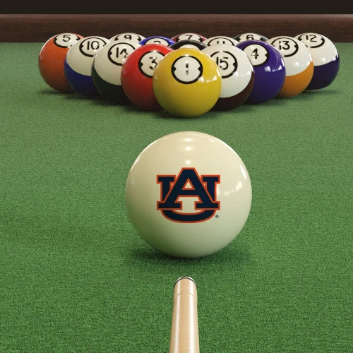 Auburn Tigers cue ball positioned on green pool table felt in front of a racked set of billiard balls, featuring the navy blue and orange AU logo with a pool cue lined up for the break.