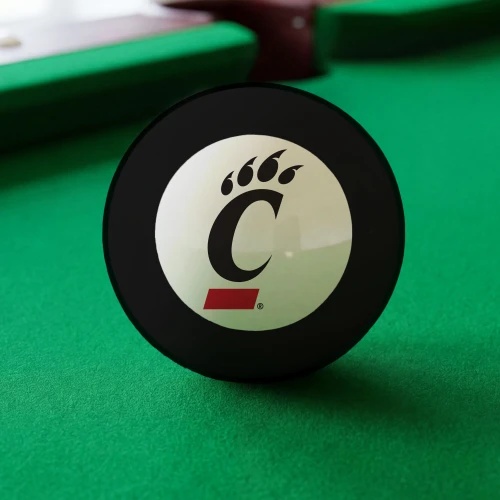 Cincinnati Bearcats Eight Ball displayed on green pool table felt, featuring the black and red Cincinnati C-Paw logo inside the white center circle of a classic black billiard Eight Ball.