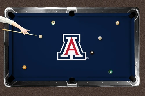Arizona Wildcats blue logo billiard cloth shown installed on a full-size pool table during play. The blue playing surface features a large Arizona Wildcats block A logo at center with billiard balls positioned across the table and a player preparing to take a shot.

