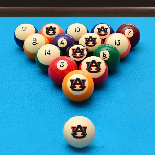 Auburn Tigers billiard balls arranged in a triangle rack on blue pool table felt, featuring interlocking “AU” graphics with a coordinating Auburn cue ball positioned in the foreground.