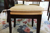 Coordinating seat cushions in Kravet Linen 32330 14 with welting in Makers Mark.