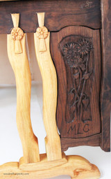 Closeup of Hand Carved Panel with Flowers and Initials of Owner of Desk.  Legs are handcarved Locust wood.