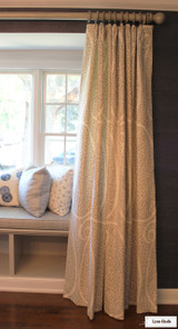 Schumacher Ambala Paisley Fog Drapes with Western Wood Supply Drapery Hardware Painted in Old Ivory. Cushion in Schumacher Travertine Linen Weave in Denim. Pillows in Groundworks Kasa and Christopher Farr Pollen. (Erika Mercurio Design)