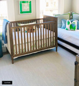 Schumacher Jungle Jubilee Leaf Green Crib Skirt and Pillow  and Christopher Farr Carnival Pillow in Nursery