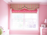 My client wanted a valance and roman shade similar to the one she saw in the magazine that I had done.  This roman shade has a border that matches the valance and a pom pom trim that has pink, green and white in it.