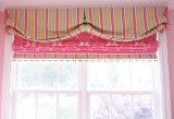 My client wanted a valance and roman shade similar to the one she saw in the magazine that I had done.  This roman shade has a border that matches the valance and a pom pom trim that has pink, green and white in it.