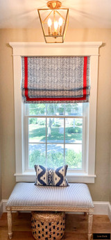 Roman Shade in Quadrille Petite Zig Zag Navy on White with Samuel & Sons Pimento Red Trim. Lumbar Pillow in Quadrille Bali Hai Custom Blues on White.