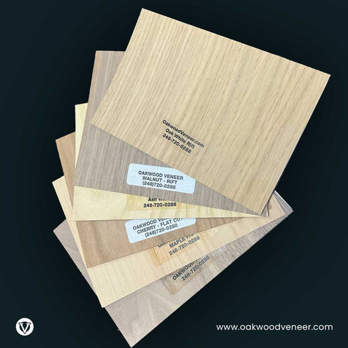 A stack of five wood veneer samples in varying shades, labeled with product details. The background is black, highlighting the textures and tones.