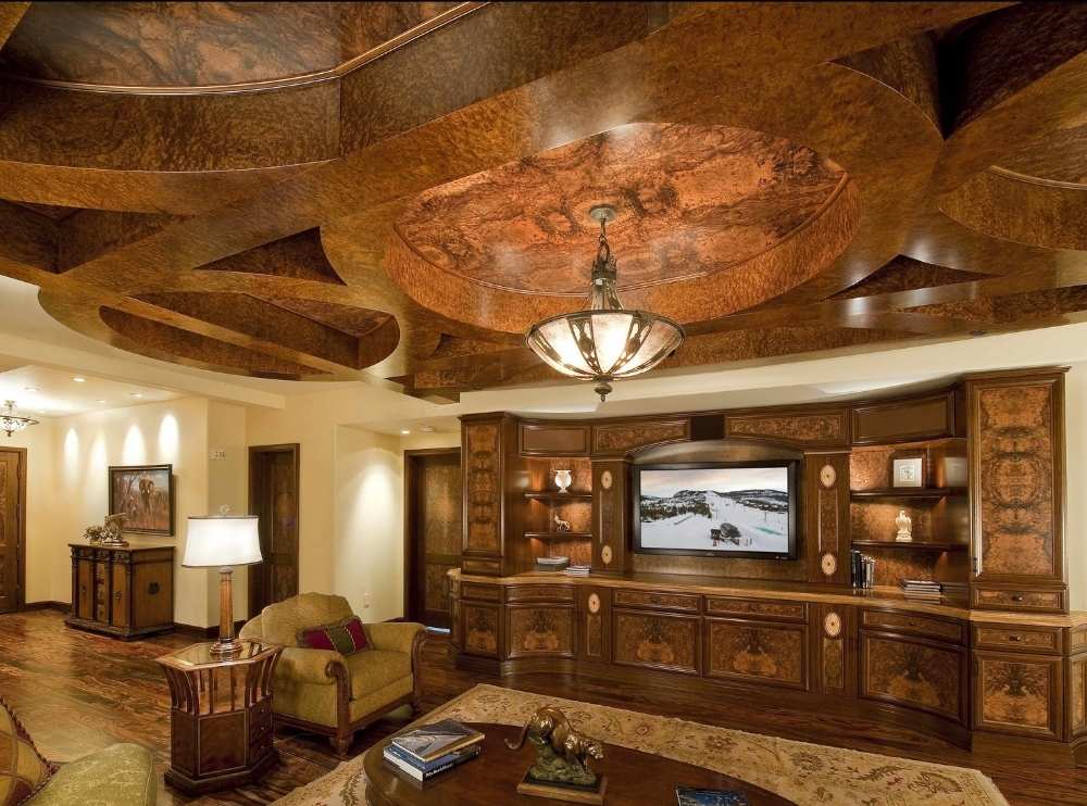 Custom wood veneer ceiling and wall panels in a luxury interior featuring dramatic, high-gloss burl veneer and built-in walnut cabinetry. Request a free quote on custom veneer sheets and panels for architectural millwork.