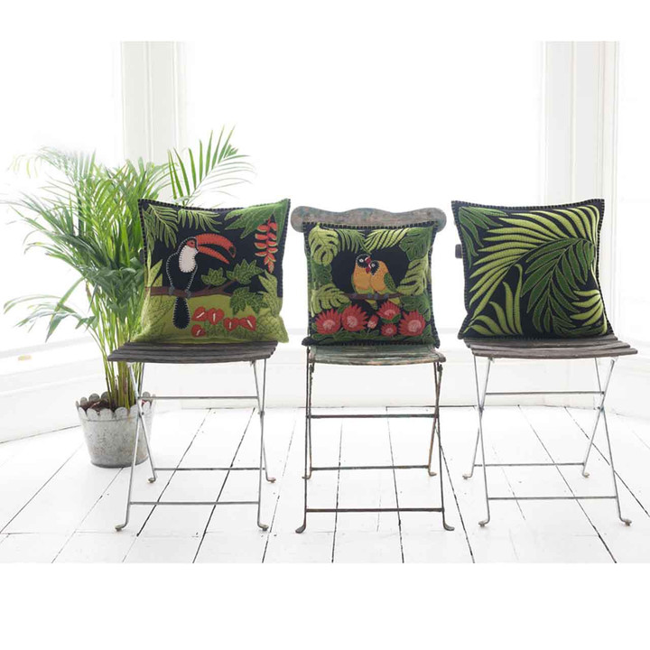 Tropical appliqué palm leaves hand-embroidered onto luxurious black wool felt cushion.