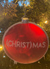 (Christ)Mas Ornament pictured hanging on a Christmas tree