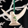 Belleek Dove Ornament shown hanging on a decorative tree