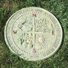 Four Seasons Garden Stepping Stone shown in a lawn