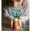 A child holding a St. Francis Shining Light Doll