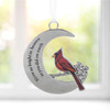 Memorial Cardinal on Moon Ornament shown in front of a window