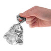 A hand ringing the Silver-Plated Make-Up Bell